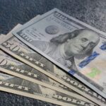 closeup-shot-three-fifty-one-hundred-dollars-bills_181624-3863